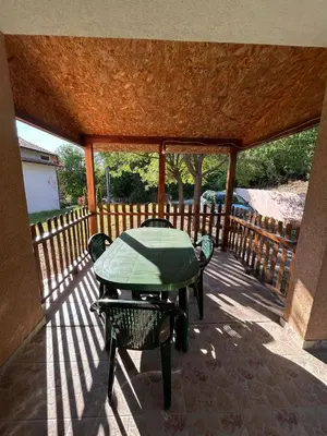 a patio with a table and chairs on a deck at Smeštaj Miok in Soko Banja