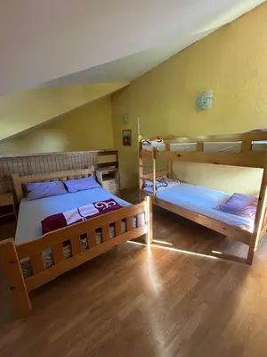 two bunk beds in a room with wooden floors at Smeštaj Miok in Soko Banja
