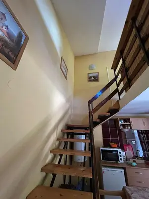 a spiral staircase in a room with a kitchen at Smeštaj Miok in Soko Banja