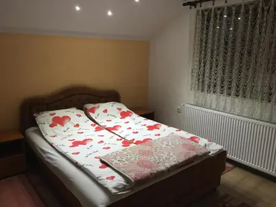 a bedroom with a bed with a pillow on it at Pansion Velickovic in Niška Banja