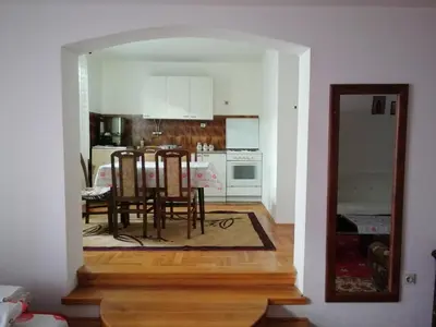a kitchen and dining room with a table and chairs at Pansion Velickovic in Niška Banja