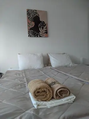 a bed with two towels sitting on top of it at Golden lady in Niš