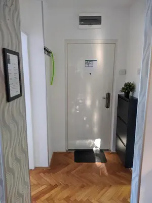 a hallway with a glass door in a room at Golden lady in Niš
