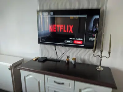 a tv on a wall with a netflix sign on it at Golden lady in Niš