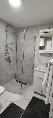 a bathroom with a shower and a sink at Apartmani Vrnjacka Banja in Vrnjci