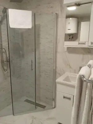 a bathroom with a shower and a sink at Apartmani Vrnjacka Banja in Vrnjci
