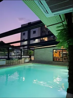 a large swimming pool in front of a building at Apartman NIKOLINA in Vrnjačka Banja