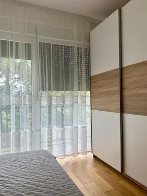 a bedroom with a bed and a large window at VIP House 4 in Vrnjačka Banja