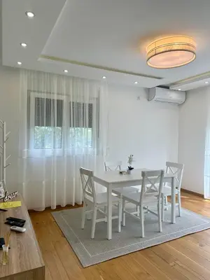 a white dining room with a white table and chairs at VIP House 4 in Vrnjačka Banja