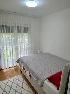 a bedroom with a bed in a room with windows at VIP House 4 in Vrnjačka Banja