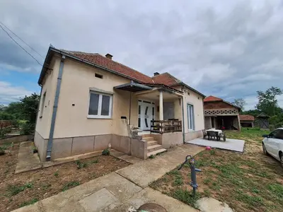 a house with a car parked in front of it at Tomić