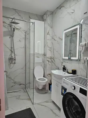 a bathroom with a toilet and a shower and a sink at Apartmani Giga in Vrnjci