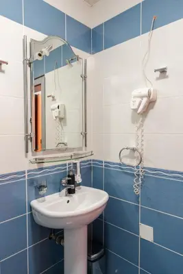 a bathroom with a sink and a mirror at Apartmani Šumadija 17 in Vrnjačka Banja