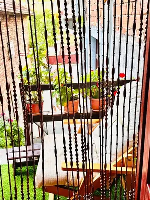 a cage filled with potted plants on a window at Apartman Aki in Vlasotince