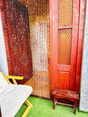a wooden door and a bench next to a fence at Apartman Aki in Vlasotince