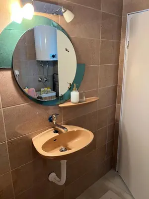 a bathroom with a sink and a mirror at Golding Lux in Soko Banja