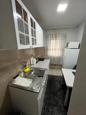 a small kitchen with a sink and a refrigerator at Golding Lux in Soko Banja