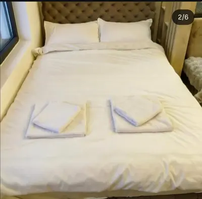 a bed with white blankets and towels on it at Residence Hill - Apartman B112A in Kopaonik