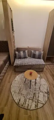 a living room with a couch and a coffee table at Residence Hill - Apartman B112A in Kopaonik