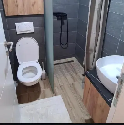 a bathroom with a toilet and a sink at Residence Hill - Apartman B112A in Kopaonik
