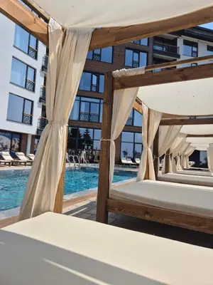 a bedroom with two beds next to a pool at Residence Hill - Apartman B112A in Kopaonik