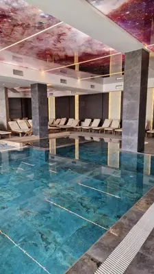 a large swimming pool with a painting on the ceiling at Residence Hill - Apartman B112A in Kopaonik
