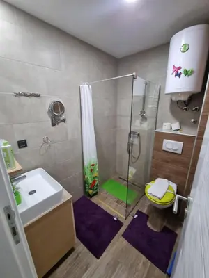 a bathroom with a shower and a sink at Kopaonik, Milmari resort, Apartman Duga in Kopaonik