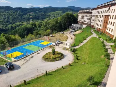 an aerial view of a building and a pool at Kopaonik, Milmari resort, Apartman Duga in Kopaonik