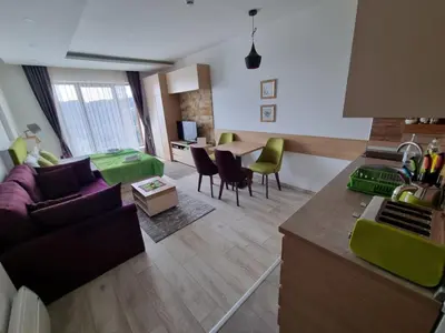 a living room with a couch and a table at Kopaonik, Milmari resort, Apartman Duga in Kopaonik