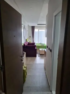 a hallway with a living room with a couch at Kopaonik, Milmari resort, Apartman Duga in Kopaonik