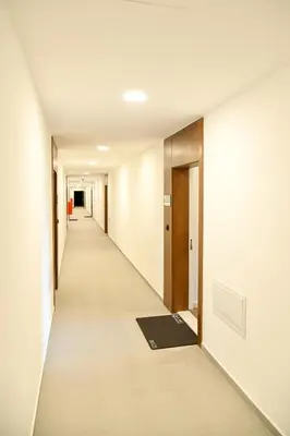 an empty corridor of an office building with a hallway at Residence LUX in Niš