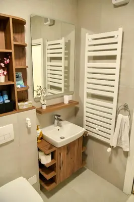 a bathroom with a sink and a mirror at Residence LUX in Niš
