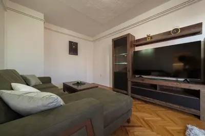 a living room with a couch and a large flat screen tv at Apartman ANJA LUX01 in Pirot