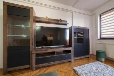 a large entertainment center with a flat screen tv at Apartman ANJA LUX01 in Pirot
