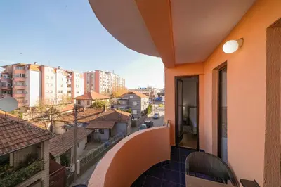 a balcony with a view of a city with buildings at Apartman ANJA LUX01 in Pirot