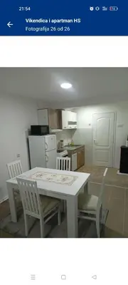 a kitchen with a table and chairs in a room at Vikendica i apartman HS in Pirot