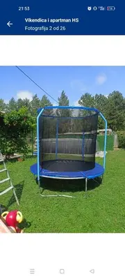 a picture of a blue trampoline in the grass at Vikendica i apartman HS in Pirot