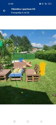 a picture of two chairs and a table on the grass at Vikendica i apartman HS in Pirot