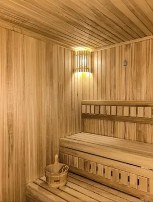 a wooden sauna with a bench and a light in it at Kopaonik,President kop Katarina free wellness&spa in Kopaonik
