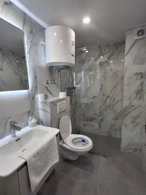 a bathroom with a toilet and a sink and a shower at Kopaonik,President kop Katarina free wellness&spa in Kopaonik