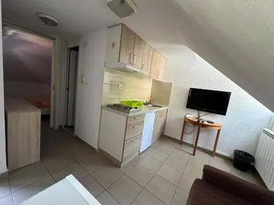 a small kitchen with a sink and a tv at Studio - Apartmani 3 in Jošanička Banja