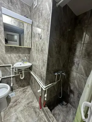 a bathroom with a sink and a toilet and a mirror at Studio - Apartmani 3 in Jošanička Banja
