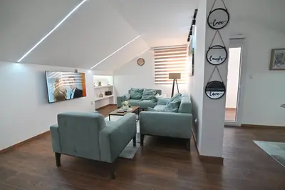 a living room with a couch and a chair at Lux&Spa Petko in Pirot