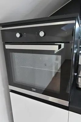 a black oven with a glass door in a kitchen at Lux&Spa Petko in Pirot