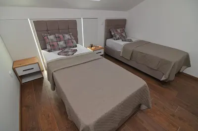 two beds in a small room with two beds sidx sidx sidx at Lux&Spa Petko in Pirot