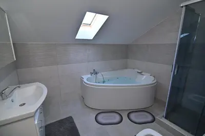 a bathroom with a tub and a shower and a sink at Lux&Spa Petko in Pirot
