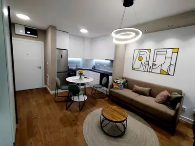 a living room with a couch and a table at Urban Elegance SPA Studio in Niš