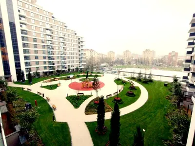 a park in the middle of a city with buildings at Urban Elegance SPA Studio in Niš