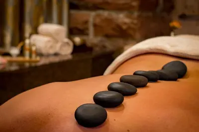 a group of black rocks on the back of a stomach at Urban Elegance SPA Studio in Niš
