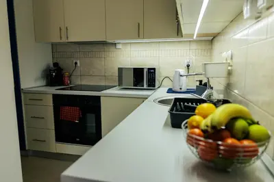 a kitchen with a bowl of fruit on a counter at WellNest Niš Self Check-in & Parking I Moderan, miran apartman plus radni kutak in Niš